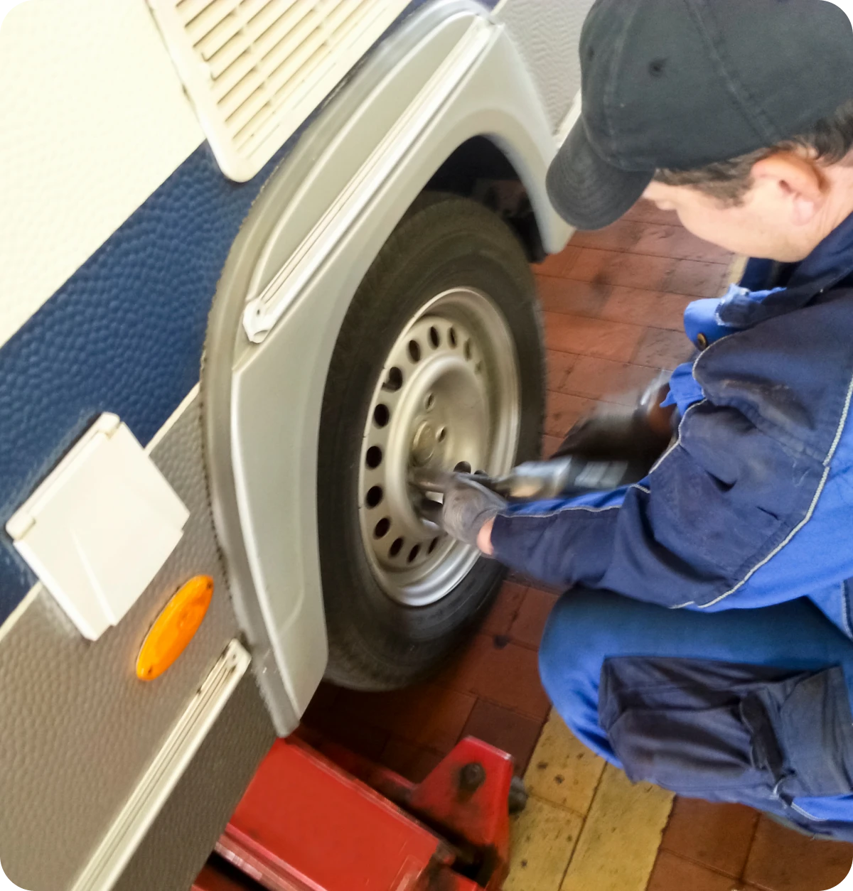 Mechanic working on vehicle tire